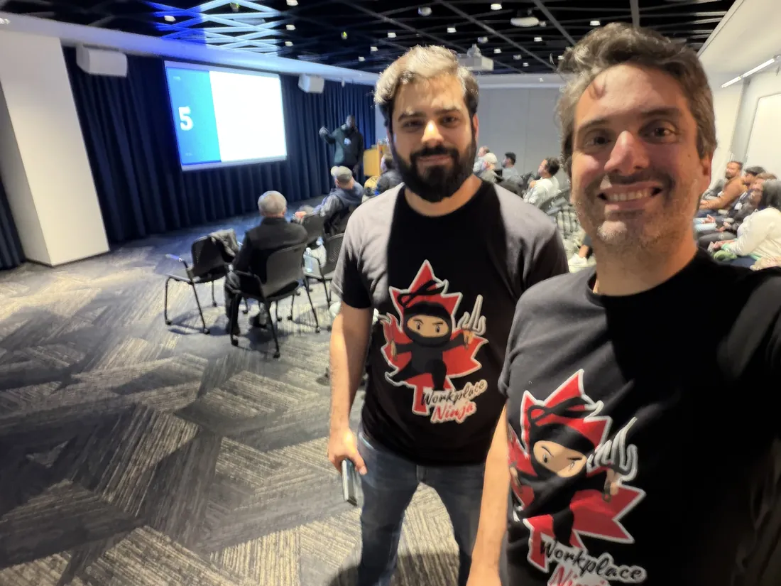 David Nudelman and Ali Alame in Workplace Ninja Canada t-shirts at the back of the room